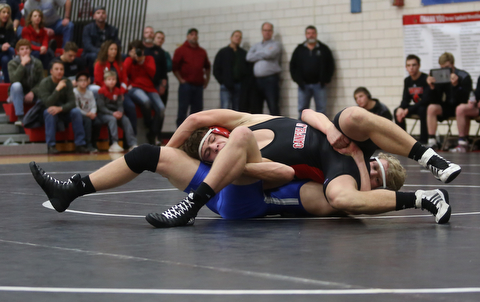 Canfield's Seth Hull(black) tries to escape Reynold's Hunter Thompson(blue) during a OSHAA 160 pound wrestling tournament, Saturday, Dec. 16, 2017, in Canfield. ..(Nikos Frazier | The Vindicator)