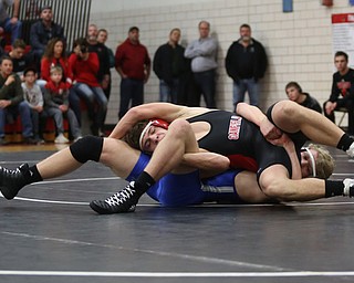 Canfield's Seth Hull(black) tries to escape Reynold's Hunter Thompson(blue) during a OSHAA 160 pound wrestling tournament, Saturday, Dec. 16, 2017, in Canfield. ..(Nikos Frazier | The Vindicator)
