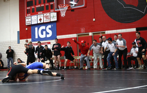 The Canfield bench erupts as Canfield's Seth H Hull ill(black) pins Reynold's Hunter Thompson(blue) during a OSHAA 160 pound wrestling tournament, Saturday, Dec. 16, 2017, in Canfield. ..(Nikos Frazier | The Vindicator)