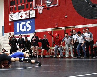 The Canfield bench erupts as Canfield's Seth H Hull ill(black) pins Reynold's Hunter Thompson(blue) during a OSHAA 160 pound wrestling tournament, Saturday, Dec. 16, 2017, in Canfield. ..(Nikos Frazier | The Vindicator)
