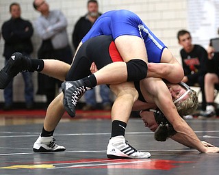 The Canfield bench erupts as Canfield's Seth Hull(black) pins Reynold's Hunter Thompson(blue) during a OSHAA 160 pound wrestling tournament, Saturday, Dec. 16, 2017, in Canfield. ..(Nikos Frazier | The Vindicator)