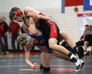 Canfield's Seth Hull(black) throws Reynold's Hunter Thompson(blue) to the mat during a OSHAA 160 pound wrestling tournament, Saturday, Dec. 16, 2017, in Canfield. ..(Nikos Frazier | The Vindicator)