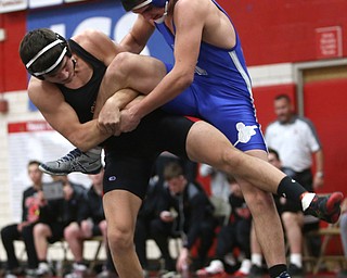 Canfield's Ben Cutrer(black) grips onto Reynold's Cole Toy(blue) during a OSHAA 170 pound wrestling tournament, Saturday, Dec. 16, 2017, in Canfield. ..(Nikos Frazier | The Vindicator)