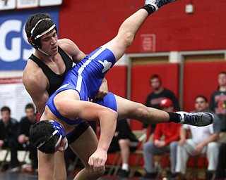 Canfield's Ben Cutrer(black) flips Reynold's Cole Toy(blue) during a OSHAA 170 pound wrestling tournament, Saturday, Dec. 16, 2017, in Canfield. ..(Nikos Frazier | The Vindicator)
