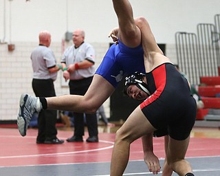 Canfield's Ben Cutrer(black) flips Reynold's Cole Toy(blue) during a OSHAA 170 pound wrestling tournament, Saturday, Dec. 16, 2017, in Canfield. ..(Nikos Frazier | The Vindicator)