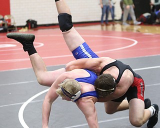Canfield's Tyler Stein(black) throws Reynold's Xavier Coburn(blue) during a OSHAA 220 pound wrestling tournament, Saturday, Dec. 16, 2017, in Canfield. ..(Nikos Frazier | The Vindicator)