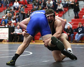 Canfield's Tyler Stein(black) attempts to overpower Reynold's Xavier Coburn(blue) during a OSHAA 220 pound wrestling tournament, Saturday, Dec. 16, 2017, in Canfield. ..(Nikos Frazier | The Vindicator)