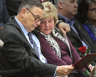 William D Lewis The Vindicator  David and Pat Leo, parents of slain Girard Police Officer Justin Leo look over the diploma their son was awarded during 12-17-17 commencement ceremony.