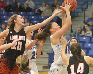 William D. Lewis the vindicator Poland's Kailyn Brown(14) shoots past Howland's Alex Ochman(20)and Kendyl Buckley(14) during 12-18-17 action at Poland.
