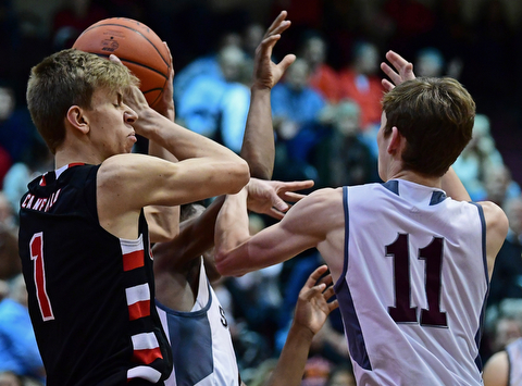 BOARDMAN, OHIO - DECEMBER 19, 2017: Canfield's Aydin Hanousek grabs a rebound away from Boardman's Billy Cammack during the first half of their game, Tuesday night at Boardman High School. DAVID DERMER | THE VINDICATOR