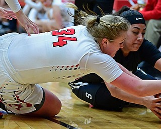 YOUNGSTOWN, OHIO - DECEMBER 20, 2017: Youngstown State's McKenah Peters dives to fight for the ball with Penn State Beaver's Cheyenne Lopez during the second half of their game on Wednesday morning at Beeghley Center. DAVID DERMER | THE VINDICATOR