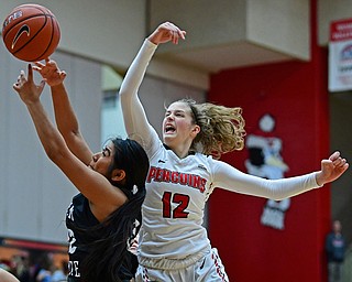 YOUNGSTOWN, OHIO - DECEMBER 20, 2017: Youngstown State's Chelsea Olson knocks the ball out of the hands of Penn State Beaver's Ryanne Kie during the second half of their game on Wednesday morning at Beeghley Center. DAVID DERMER | THE VINDICATOR