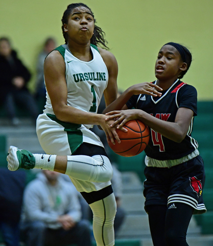 YOUNGSTOWN, OHIO - DECEMBER 20, 2017: Ursuline's Dayshanette Harris has the ball ripped from her hands by Shaw's Deleah Gibson during the first half of their game, Tuesday night at Ursuline High School. DAVID DERMER | THE VINDICATOR