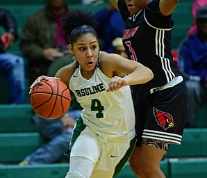 YOUNGSTOWN, OHIO - DECEMBER 20, 2017: Ursuline's Nomiki Willis drives on Shaw's Paula Taylor during the first half of their game, Tuesday night at Ursuline High School. DAVID DERMER | THE VINDICATOR