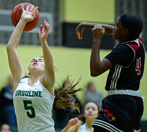 YOUNGSTOWN, OHIO - DECEMBER 20, 2017: Ursuline's Cara McNally has the ball knocked away from her by Shaw's Deleah Gibson during the first half of their game, Tuesday night at Ursuline High School. DAVID DERMER | THE VINDICATOR