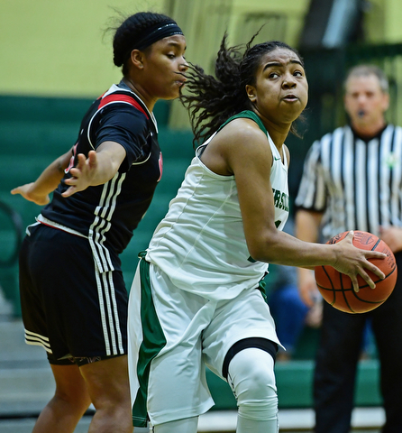 YOUNGSTOWN, OHIO - DECEMBER 20, 2017: Ursuline's Dayshanette Harris drives to the basket against Shaw's Paula Taylor during the first half of their game, Tuesday night at Ursuline High School. DAVID DERMER | THE VINDICATOR