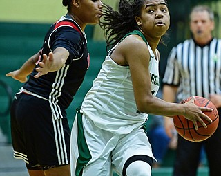 YOUNGSTOWN, OHIO - DECEMBER 20, 2017: Ursuline's Dayshanette Harris drives to the basket against Shaw's Paula Taylor during the first half of their game, Tuesday night at Ursuline High School. DAVID DERMER | THE VINDICATOR