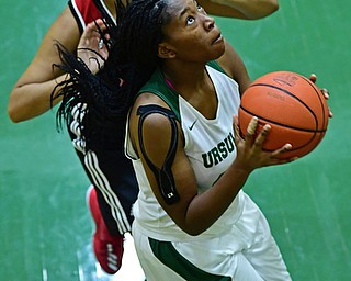 YOUNGSTOWN, OHIO - DECEMBER 20, 2017: Ursuline's Anyah Curd goes to the basket Shaw's Alexis Johnson during the first half of their game, Tuesday night at Ursuline High School. DAVID DERMER | THE VINDICATOR