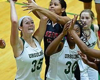 YOUNGSTOWN, OHIO - DECEMBER 20, 2017: Ursuline's Lindsay Bell puts up a shot over Shaw's Alexis Johnson during the first half of their game, Tuesday night at Ursuline High School. DAVID DERMER | THE VINDICATOR..Ursuline's Anyah Curd and Jamie Nelson pictured.
