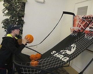 Neighbors | Zack Shively.The Austintown library had sports related games at their game day. The game pictured imitated a basketball game. The players shot the ball and scored for each made basket. The game had two hoops so players could play against family or friends or just play by themselves.