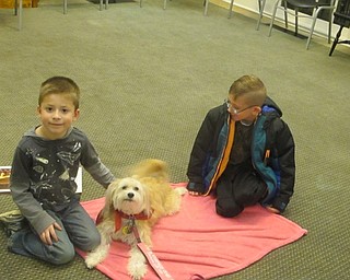 Neighbors | Zack Shively.The Poland library brought in a therapy dog named Roxie for children to read to on Nov. 28. Pictured are, from left, Kohler Salamon, Roxie and Aiden McDonnell.