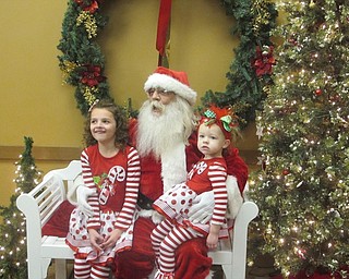 Neighbors | Zack Shively.Boardman Park hosted its 15th annual Supper with Santa event on Dec. 6 and 7. Families and children could take pictures with Santa during the event. Pictured are Rylie and Aubrie Hoover sitting with Santa at the event.