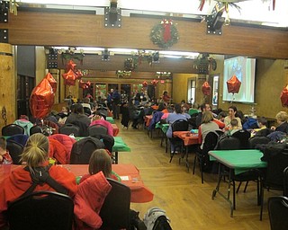 Neighbors | Zack Shively.Boardman Park treated families at their Supper with Santa event to dinner and a movie in the Lariccia Family Community Center. Families ate in the dining hall while watching "Rudolph the Red-Nosed Reindeer."