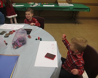 Neighbors | Zack Shively.Children could play with stamps at the Supper with Santa event on Dec. 6 and 7. The program was part of Boardman Park's holiday programming. Pictured are Kallen and Cameron stamping a piece of paper.
