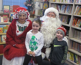 Neighbors | Zack Shively.Children sat with Mr. and Mrs. Claus in Poland Union Elementary's library during their pancake breakfast on Dec. 9. Pictured are Aliyana and Colton Broderick with Mr. and Mrs. Claus.