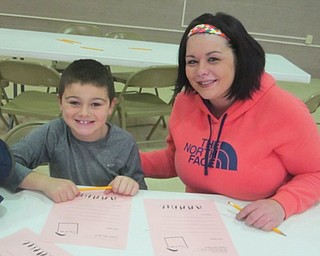Neighbors | Zack Shively.Poland Union Elementary had an area set up in their gymnasium for children to write letters to Santa. The letters were collected the library. Pictured are, from left, Gio and Jenna Nair.