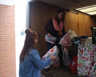 Neighbors | Abby Slanker.Canfield High School Junior Class Representative Julia Petrallo handed a donation to Student Council President Melissa Dahman as they loaded items donated from the school through the Salvation Army Angel Tag Drive on a truck destined for the distribution center on Dec. 13.