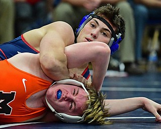 AUSTINTOWN, OHIO - DECEMBER 21, 2017: Fitch's Andrew Stehura looks to the clock while controlling the back of Massillon's Zackary Mundell during their 170lb bout, Thursday night at Austintown Fitch High School. DAVID DERMER | THE VINDICATOR