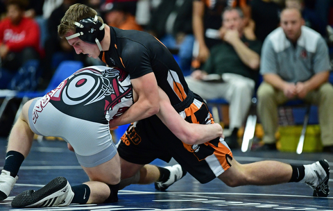 AUSTINTOWN, OHIO - DECEMBER 21, 2017: Howland's Dennis Currey sprawls in an attempt to prevent a takedown attempt from Boardman's Cade Pollak during their 145lb bout, Thursday night at Austintown Fitch High School. DAVID DERMER | THE VINDICATOR