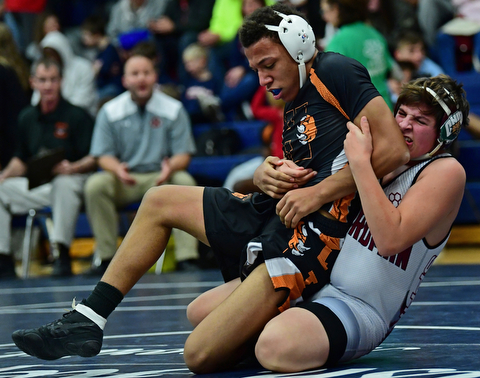 AUSTINTOWN, OHIO - DECEMBER 21, 2017: Howland's Brandon Summerlin is drug down to the mat by Boardman's John Fleet during their 160lb bout, Thursday night at Austintown Fitch High School. DAVID DERMER | THE VINDICATOR