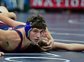 AUSTINTOWN, OHIO - DECEMBER 21, 2017: Fitch's Dom Miglets looks to the clock while working the shoulders of Howland's Dominic Sanabria to the mat during their 152lb bout, Thursday night at Austintown Fitch High School. DAVID DERMER | THE VINDICATOR