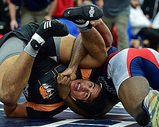 AUSTINTOWN, OHIO - DECEMBER 21, 2017: Howland's Brandon Matlock looks to break free from the control of Fitch's Breylon Douglas during their 220lb bout, Thursday night at Austintown Fitch High School. DAVID DERMER | THE VINDICATOR