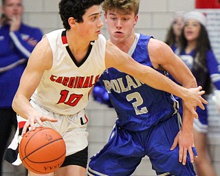 William D. Lewis The Vindictor  Poland's Danfield's Conor Crogan(10) drivespast Poland's Mike Diaz(2) during a sold out game at Canfield 12-22-17.