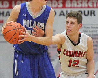 William D. Lewis The Vindictor  Poland's Daniel Kramer(10) keeps the ball from Canfield's Ethan Kalina(12) during a sold out game at Canfield 12-22-17.