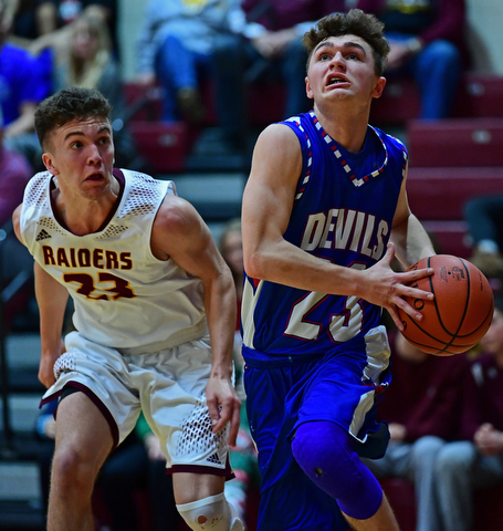CANFIELD, OHIO - DECEMBER 22, 2017: Western Reserve's Cole DaZee goes to the basket against South Range's Jaxon Anderson during the first half of their game on Friday night at South Range High School. DAVID DERMER | THE VINDICATOR