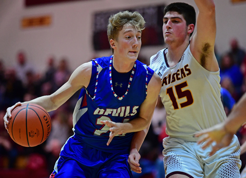 CANFIELD, OHIO - DECEMBER 22, 2017: Western Reserve's Kade Hilles, left, drives on South Range's Mike Cunningham during the first half of their game on Friday night at South Range High School. DAVID DERMER | THE VINDICATOR