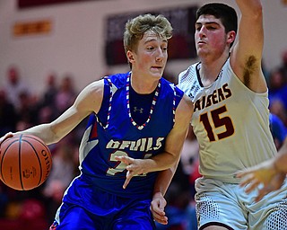 CANFIELD, OHIO - DECEMBER 22, 2017: Western Reserve's Kade Hilles, left, drives on South Range's Mike Cunningham during the first half of their game on Friday night at South Range High School. DAVID DERMER | THE VINDICATOR