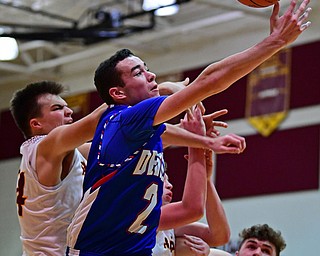 CANFIELD, OHIO - DECEMBER 22, 2017: Western Reserve's Dom Velasquez reaches for a rebound while fighting with South Range's Jake Gehring during the first half of their game on Friday night at South Range High School. DAVID DERMER | THE VINDICATOR