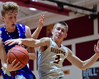 CANFIELD, OHIO - DECEMBER 22, 2017: Western Reserve's Kade Hilles grabs a rebound away from South Range's Ben Irons during the first half of their game on Friday night at South Range High School. DAVID DERMER | THE VINDICATOR