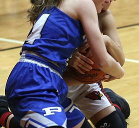Canfield guard Ashley Veneroso (23) and Poland guard Gabby Romano (34) fight for the ball in the first quarter of an AAC high school basketball game, Friday, Dec. 23, 2017, in Canfield. Canfield won 45-34...(Nikos Frazier | The Vindicator)