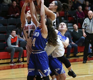 Canfield guard Serena Sammarone (54) gets the rebound  from Canfield guard Emerson Fletcher (14) Poland guard Kat Partika (22) and Poland guard Gabby Romano (34) in the first quarter of an AAC high school basketball game, Friday, Dec. 23, 2017, in Canfield. Canfield won 45-34...(Nikos Frazier | The Vindicator)