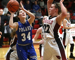 Poland guard Gabby Romano (34) goes up for a layup as Canfield post Chloe Kalina (22) goes up to block the shot in the second quarter of an AAC high school basketball game, Friday, Dec. 23, 2017, in Canfield. Canfield won 45-34...(Nikos Frazier | The Vindicator)