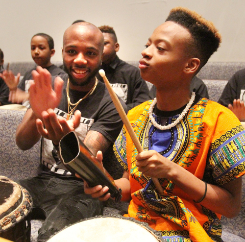 William D. Lewis  The Vindicator Antjuan Hobbs, left, and Isiah Carter both of Youngstown and members of the Harambe Youth drum group enjoy the first night of Kwanzaa at New Bethel Baptist Church in Youngstown 12-26-17.