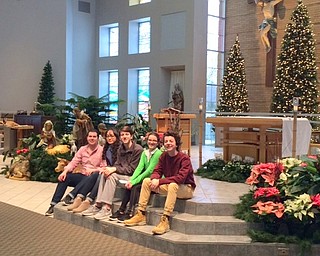 Holy Family Youth Ministry decorated Holy Family Church in Poland on Dec. 17. The group also sent Christmas cards to the sick, home-bound, nursing-home and assisted-living residents of the parish. The annual Father Richard’s Bakery took place, and all proceeds will be used for the summer mission trip. Above are Luke Politsky, art and environment chairman, and Holy Family Youth Ministry volunteers Viktorya Lange, Noah Landry, Nola Argiro and Tom Landry after decorating was finished. Below are Stephen Babik, Laura Pesko, Marisa Mangino and Lange, who prepared cards. 