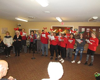 Struthers Rotary recently made a visit to Maplecrest Nursing Home in Struthers. Maplecrest treated the Rotarians and members of Struthers girls basketball team to lunch. Above, they reciprocated by caroling to the residents.