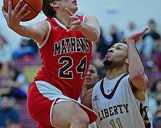 LIBERTY, OHIO - DECEMBER 27, 2017: Mathews Zak Arnio goes to the basket against Liberty's Kevin Code during the first half of their game on Wednesday night at Liberty High School. DAVID DERMER | THE VINDICATOR